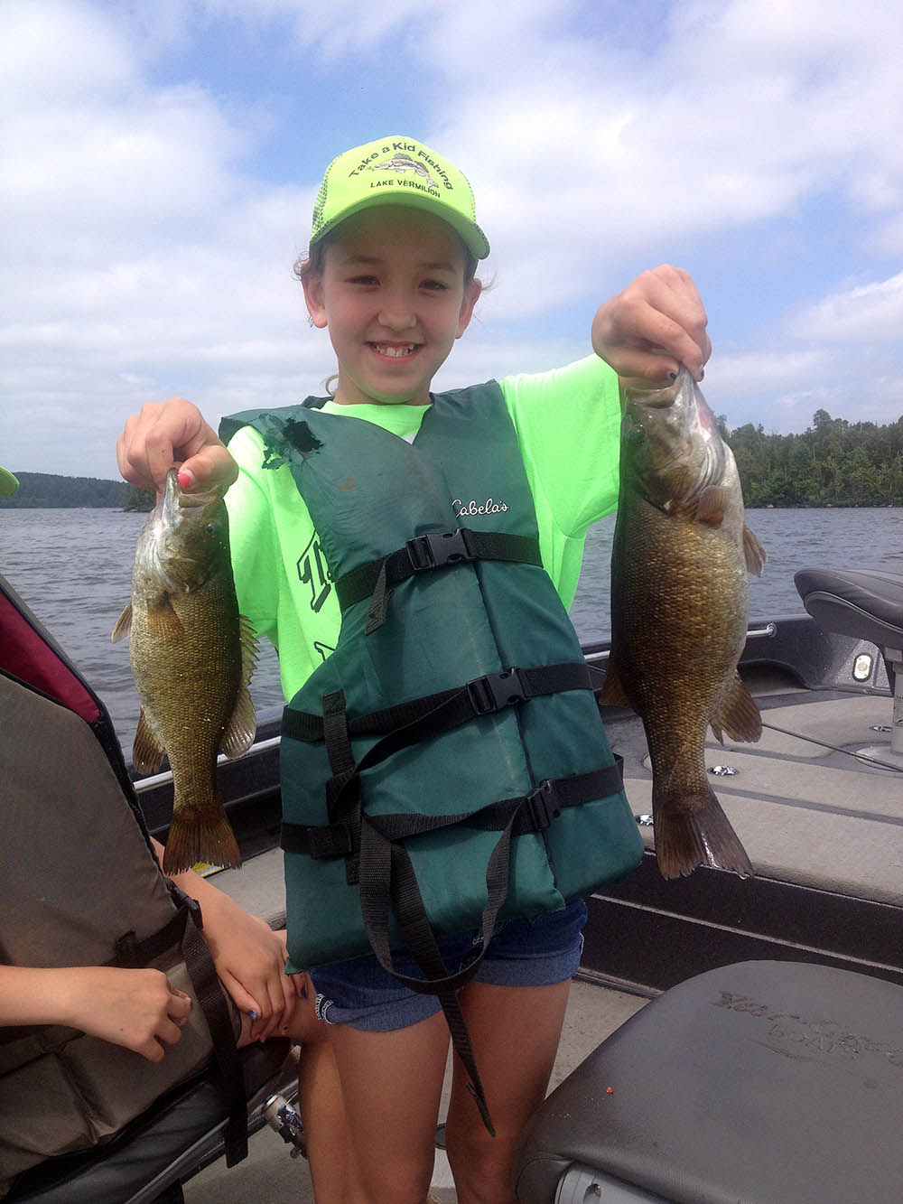 Girl posing with two caught fish